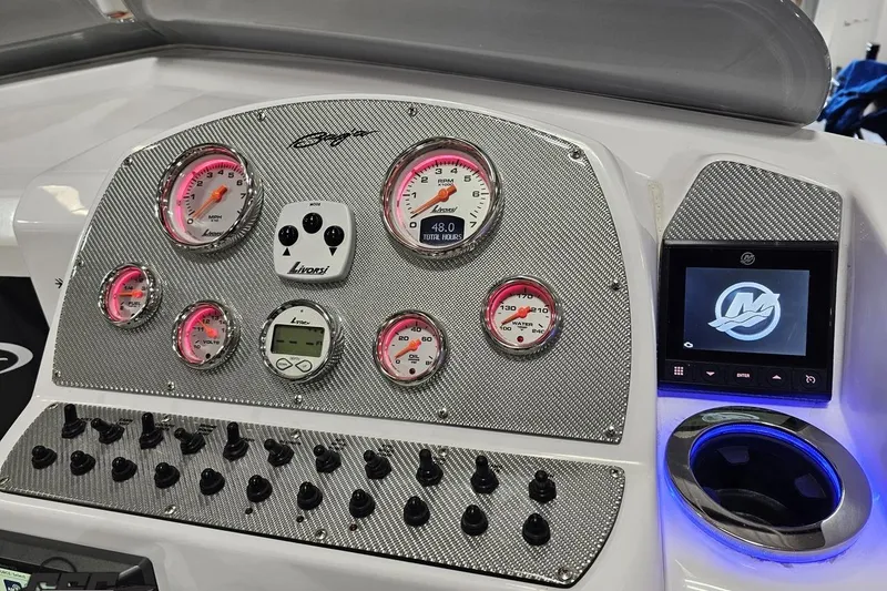 Slide: The Image of Dashboard of a 2018 Baja 24 Outlaw boat with gauges and controls. - 115