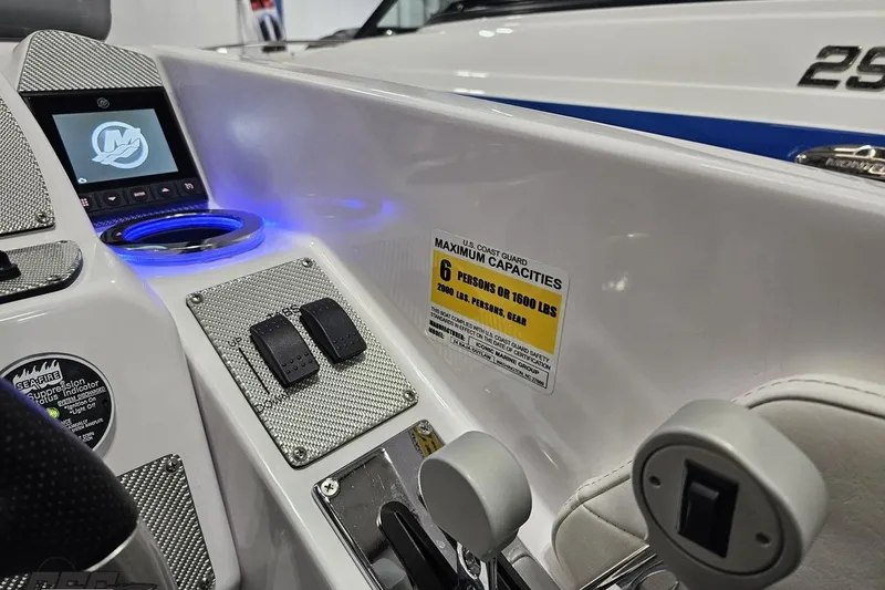 Slide: The Image of 2018 Baja 24 Outlaw boat dashboard with controls and capacity label. - 116