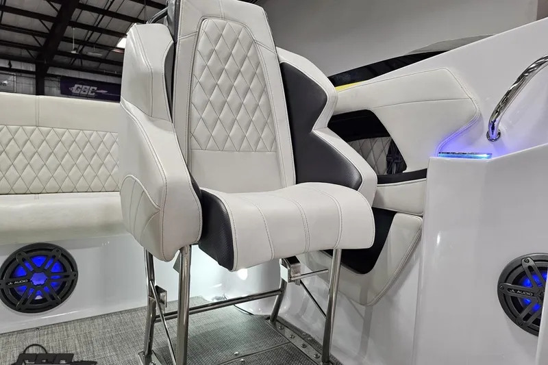 Slide: The Image of 2018 Baja 24 Outlaw boat interior with white leather seating and blue LED lighting. - 117