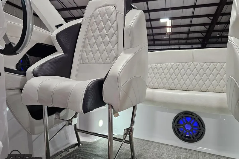 Slide: The Image of 2018 Baja 24 Outlaw boat interior with diamond-stitched seats and JL Audio speaker. - 118