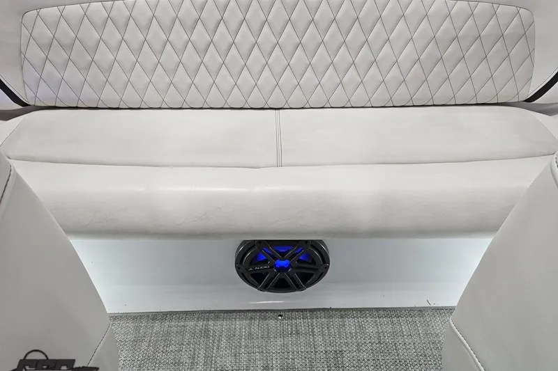 Slide: The Image of 2018 Baja 24 Outlaw boat interior with diamond-stitched seating and JL Audio speaker. - 119