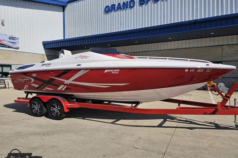 Slide: The Image of 2018 Baja 24 Outlaw speedboat with red and white design on a trailer. - 12
