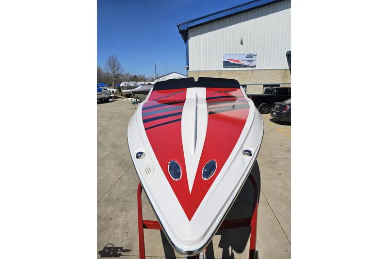 Slide: The Image of 2018 Baja 24 Outlaw speedboat with red and white design, displayed outdoors. - 14