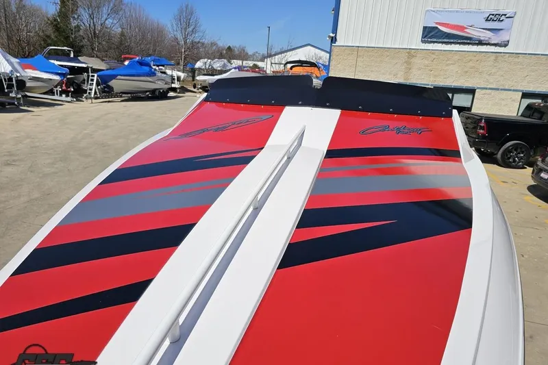 Slide: The Image of 2018 Baja 24 Outlaw boat with red and black graphics in a marina setting. - 15