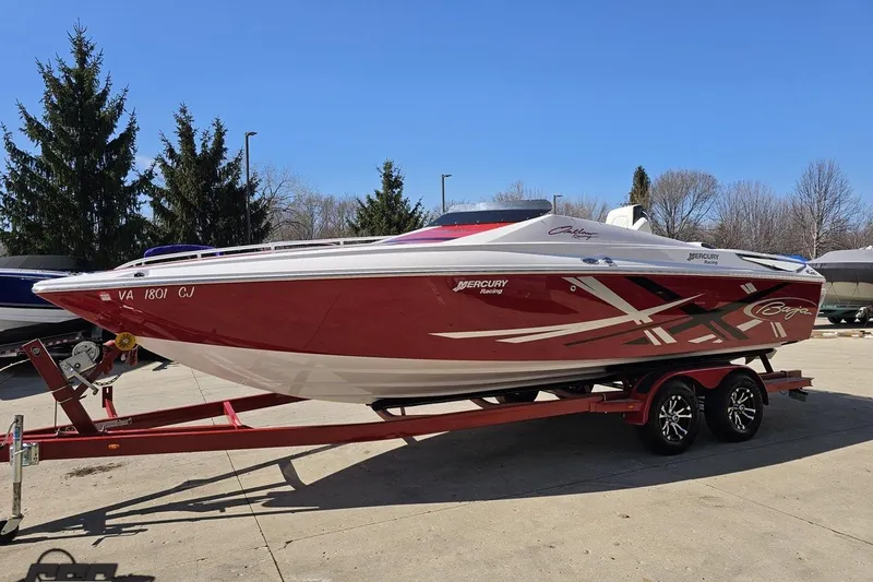 Slide: The Image of 2018 Baja 24 Outlaw speedboat on trailer, red and white design, parked outdoors. - 19