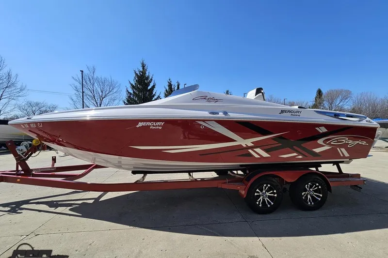 Slide: The Image of 2018 Baja 24 Outlaw speedboat on trailer, red and white design, parked outdoors. - 20