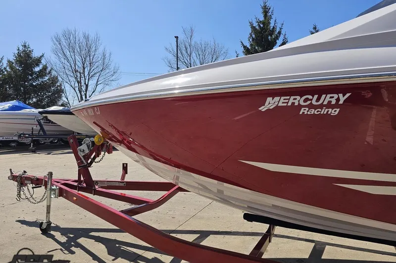 Slide: The Image of 2018 Baja 24 Outlaw boat with Mercury Racing logo on a trailer. - 22