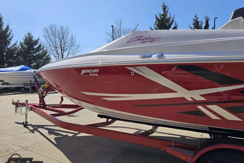 Slide: The Image of 2018 Baja 24 Outlaw boat with red and white racing design on trailer. - 23