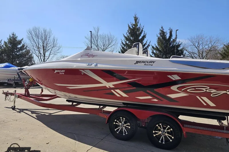 Slide: The Image of 2018 Baja 24 Outlaw speedboat on trailer, featuring red and white design with Mercury Racing logo. - 24