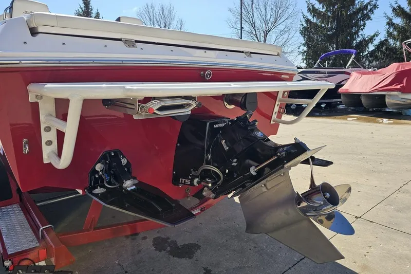 Slide: The Image of 2018 Baja 24 Outlaw boat stern with propeller and outdrive, parked outdoors. - 27