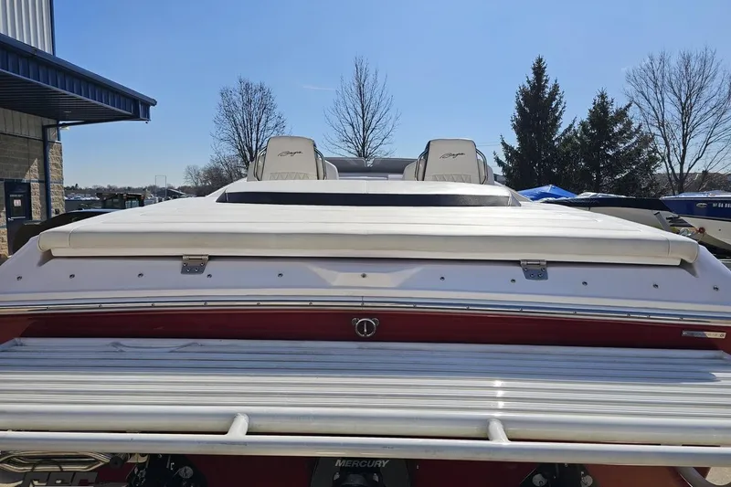Slide: The Image of 2018 Baja 24 Outlaw boat, rear view, parked outdoors under clear blue sky. - 38