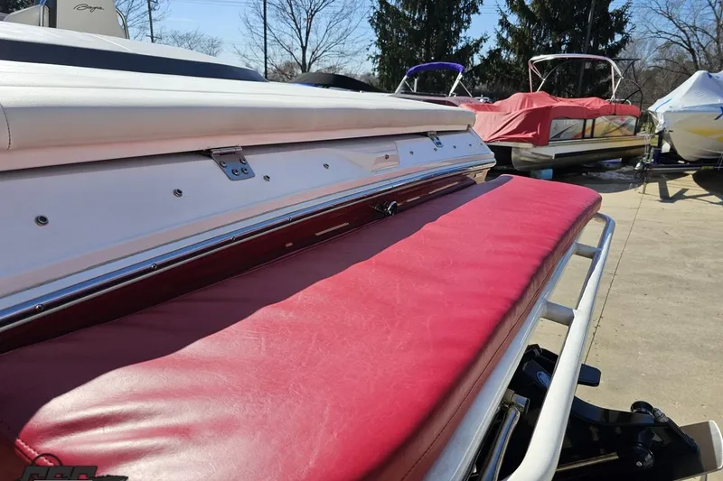 Slide: The Image of 2018 Baja 24 Outlaw boat with red seating, parked outdoors. - 39