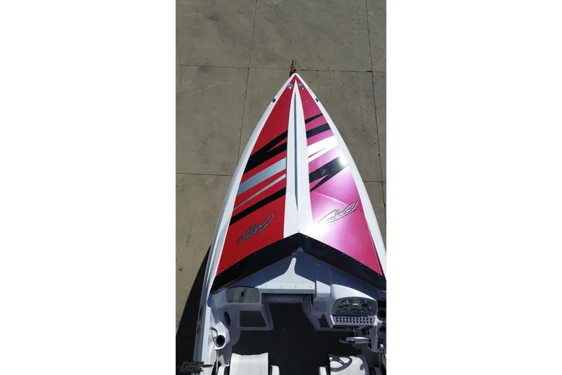 Slide: The Image of 2018 Baja 24 Outlaw boat with vibrant red and black design, viewed from above. - 42