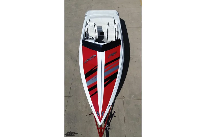 Slide: The Image of 2018 Baja 24 Outlaw speedboat with striking red and black design on concrete surface. - 43