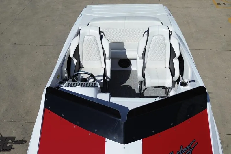 Slide: The Image of 2018 Baja 24 Outlaw boat interior with white seats and red dashboard. - 45