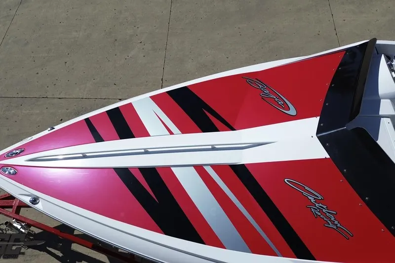 Slide: The Image of 2018 Baja 24 Outlaw boat with red and black graphics on the deck. - 46