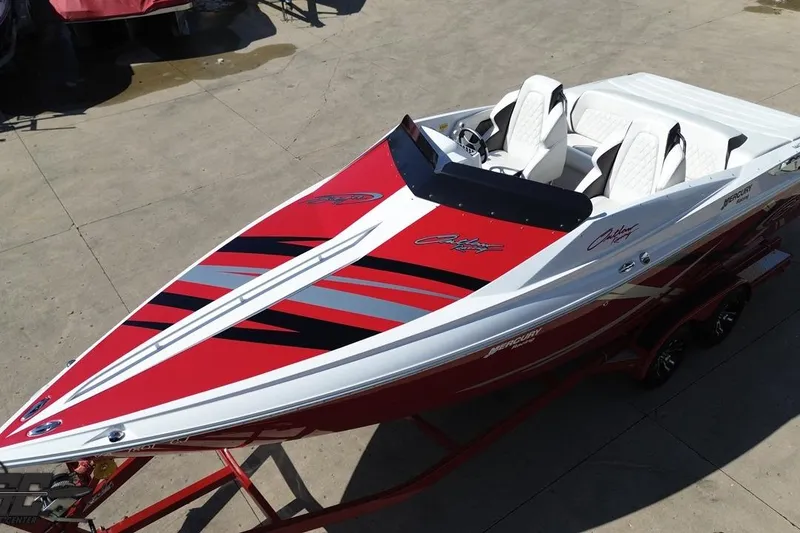 Slide: The Image of 2018 Baja 24 Outlaw speedboat with red and white design on a trailer. - 47