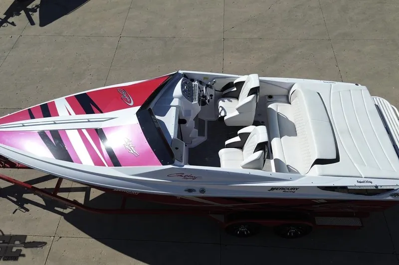Slide: The Image of 2018 Baja 24 Outlaw speedboat with vibrant pink and black design, white interior seating. - 48