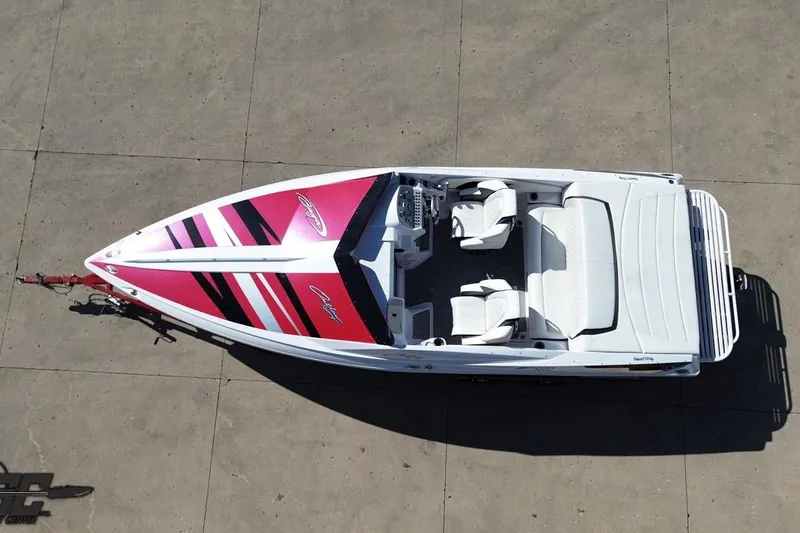 Slide: The Image of Overhead view of a 2018 Baja 24 Outlaw speedboat with vibrant pink and black design. - 49