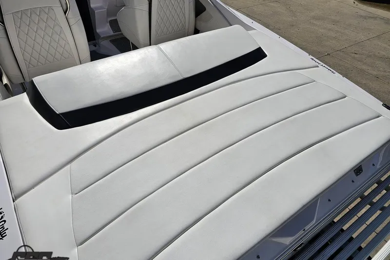 Slide: The Image of 2018 Baja 24 Outlaw boat interior with white cushioned seating and diamond-stitched design. - 50