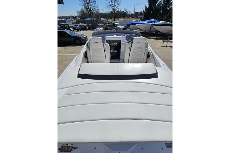Slide: The Image of 2018 Baja 24 Outlaw boat with white seating, parked outdoors. - 51