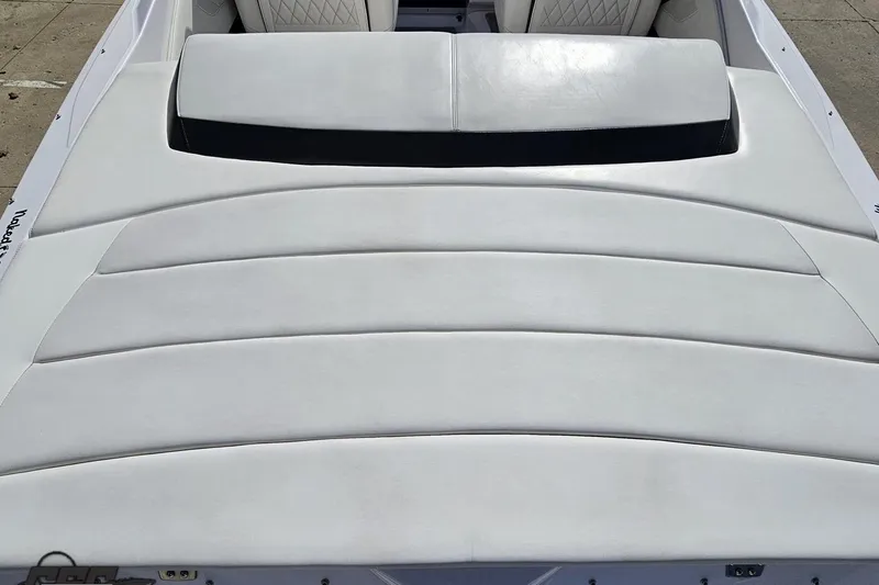 Slide: The Image of 2018 Baja 24 Outlaw boat with white cushioned seating and sleek design. - 52