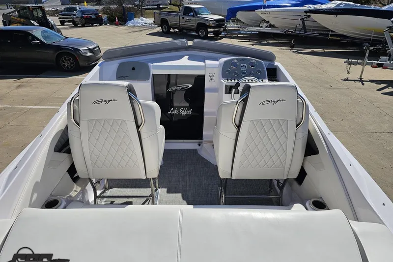 Slide: The Image of 2018 Baja 24 Outlaw boat interior with white leather seats and dashboard controls. - 53
