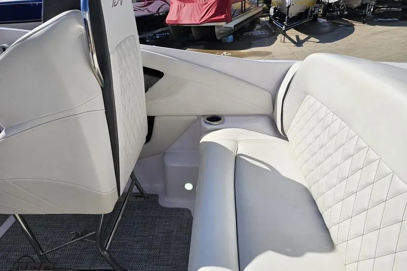 Slide: The Image of Interior of a 2018 Baja 24 Outlaw boat with white leather seating. - 57