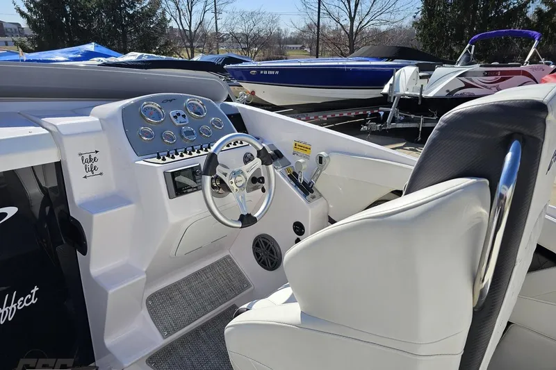 Slide: The Image of 2018 Baja 24 Outlaw boat cockpit with steering wheel and control panel. - 58