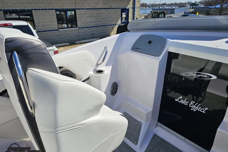 Slide: The Image of 2018 Baja 24 Outlaw boat interior with white seating and "Lake Effect" decal. - 60