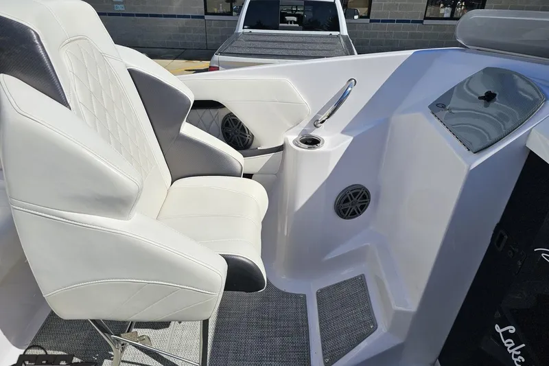 Slide: The Image of 2018 Baja 24 Outlaw boat interior with white seating and modern dashboard design. - 61