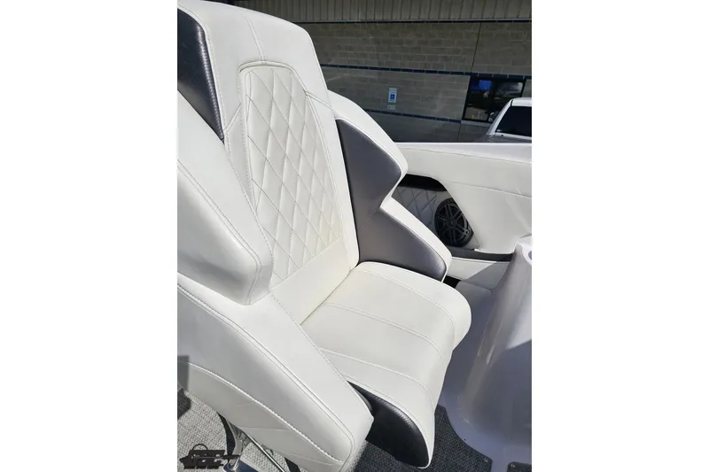 Slide: The Image of 2018 Baja 24 Outlaw boat seat with white and gray upholstery, diamond stitching. - 62