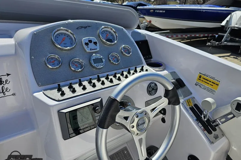 Slide: The Image of Cockpit of 2018 Baja 24 Outlaw boat with steering wheel and control panel. - 68