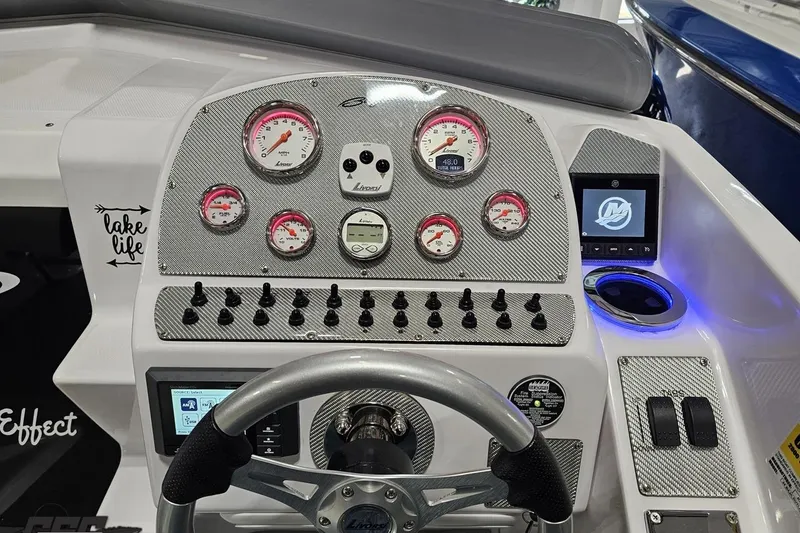 Slide: The Image of Dashboard of a 2018 Baja 24 Outlaw boat with gauges and controls. - 74