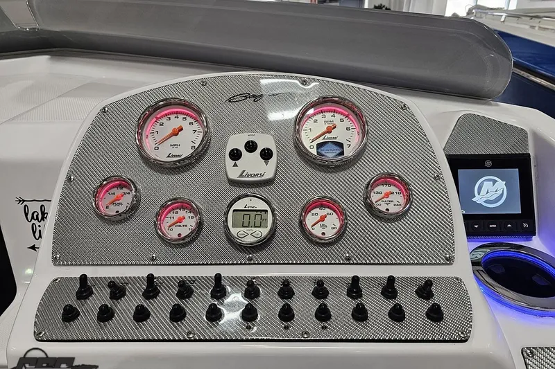 Slide: The Image of Dashboard of a 2018 Baja 24 Outlaw boat with gauges and controls. - 76