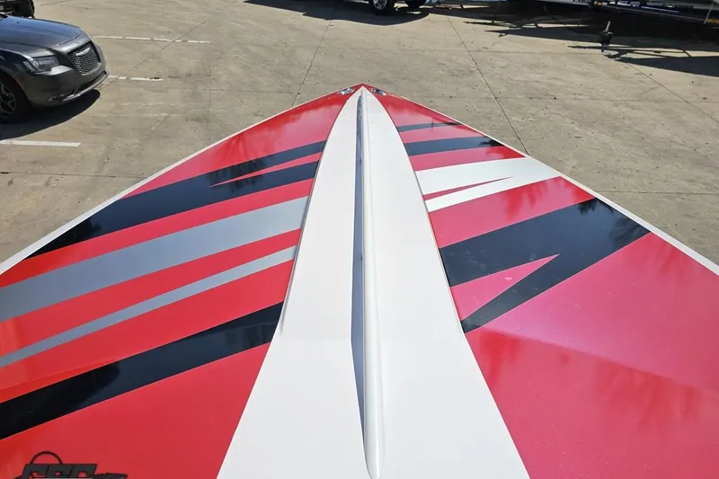 Slide: The Image of 2018 Baja 24 Outlaw boat with vibrant red and black graphics on deck. - 80