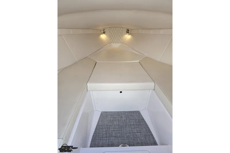 Slide: The Image of Interior cabin of 2018 Baja 24 Outlaw boat with white upholstery and lighting. - 84