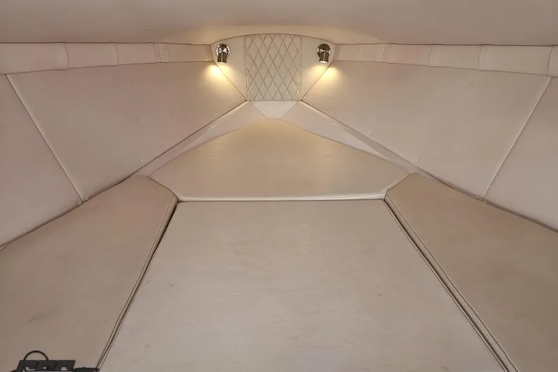 Slide: The Image of Interior cabin of 2018 Baja 24 Outlaw boat with cushioned seating and ambient lighting. - 85