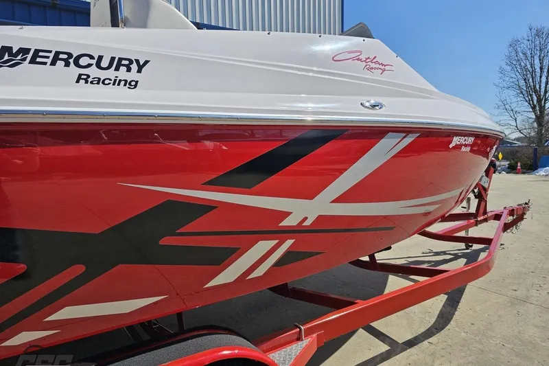 Slide: The Image of 2018 Baja 24 Outlaw boat with red and black racing graphics on a trailer. - 9
