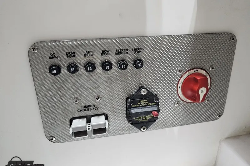Slide: The Image of Control panel of a 2018 Baja 24 Outlaw boat with switches and circuit breaker. - 92