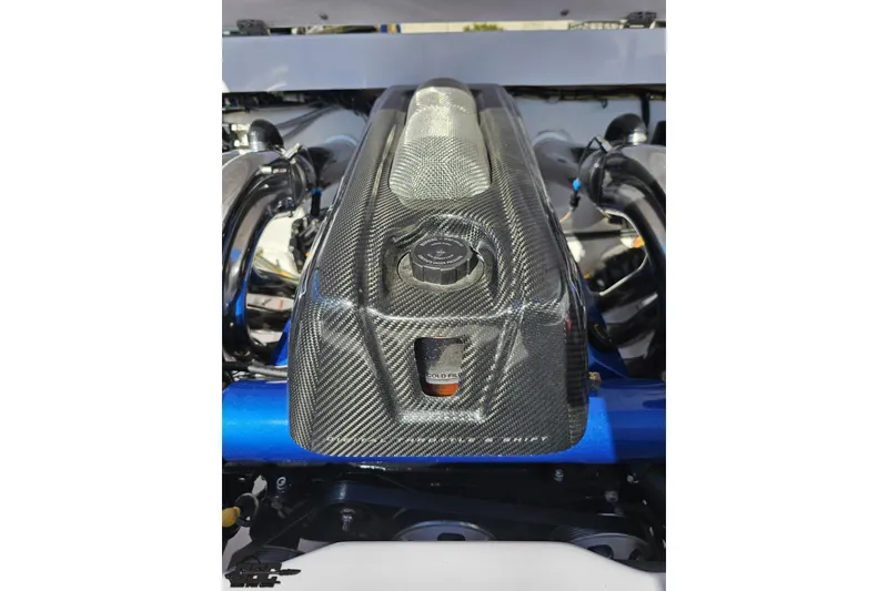 Slide: The Image of Carbon fiber engine cover of a 2018 Baja 24 Outlaw boat. - 96