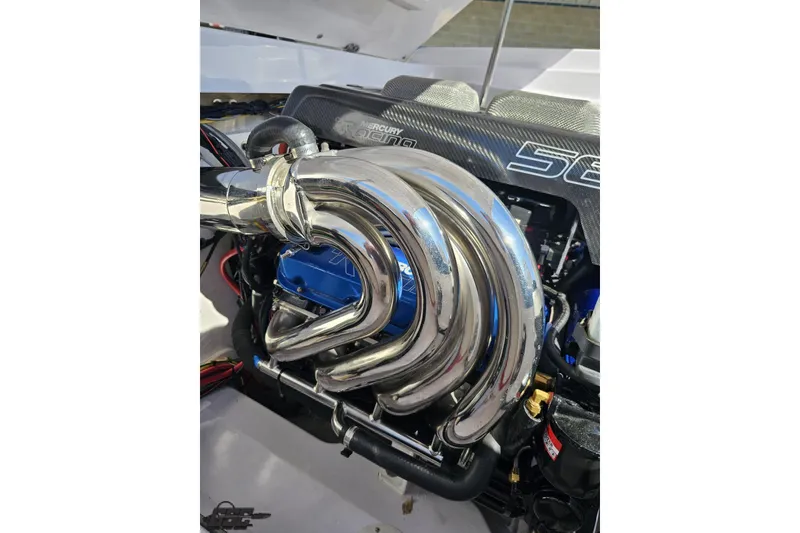 Slide: The Image of 2018 Baja 24 Outlaw engine with polished exhaust headers and Mercury branding. - 98