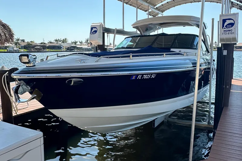 The Image of 2020 Formula 350 Crossover Bowrider docked at marina, blue and white design. - 0
