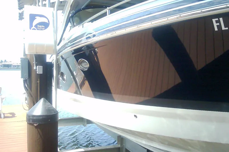 Slide: The Image of 2020 Formula 350 Crossover Bowrider docked at marina, reflecting water and surroundings. - 11