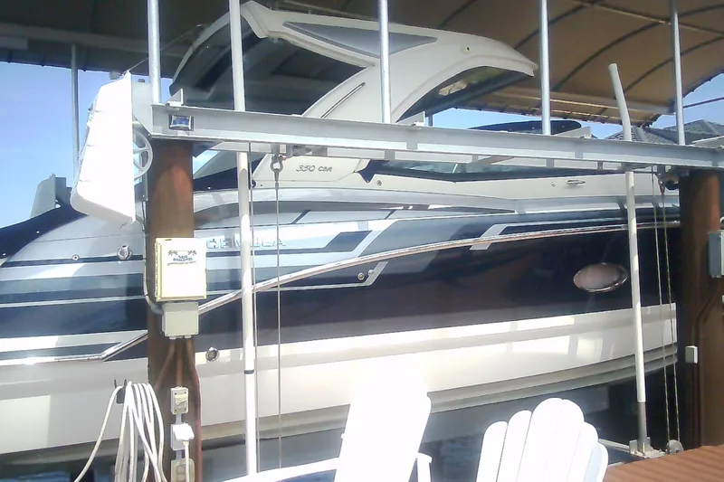 Slide: The Image of 2020 Formula 350 Crossover Bowrider docked under a covered marina. - 13