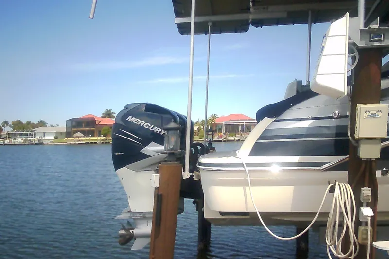 Slide: The Image of 2020 Formula 350 Crossover Bowrider with Mercury outboard engine docked by waterfront homes. - 14