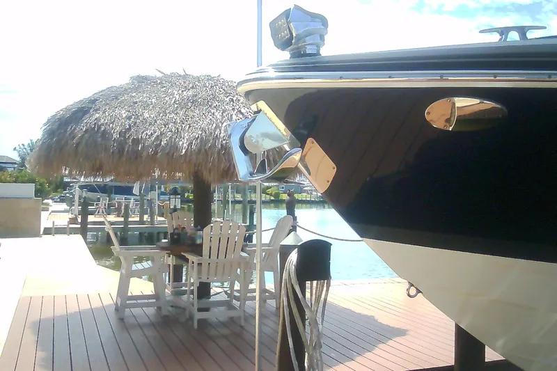 Slide: The Image of 2020 Formula 350 Crossover Bowrider docked near a thatched-roof seating area. - 18