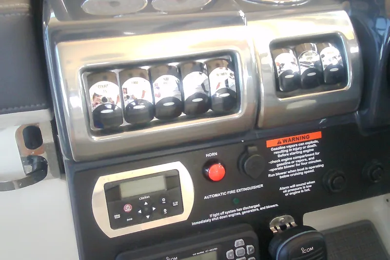 Slide: The Image of Control panel of a 2020 Formula 350 Crossover Bowrider boat with switches and warning labels. - 31