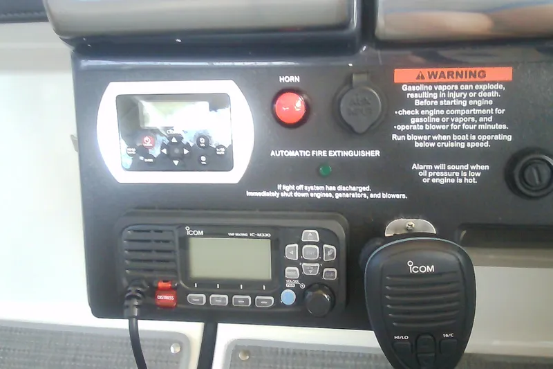 Slide: The Image of Control panel of a 2020 Formula 350 Crossover Bowrider with ICOM radio and safety warnings. - 35