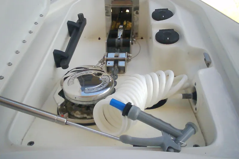 Slide: The Image of 2020 Formula 350 Crossover Bowrider anchor compartment with coiled hose and winch. - 65